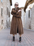 Elegant vintage Canadian brown mink fur coat with silk lining and stylish sunglasses, displayed in a charming cobblestone street setting.