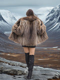 Back view of Raccoon Glamour Jacket - Mountain Mirage S/M with arms outstretched, highlighting full fur coverage and mountain fashion.