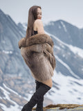 Raccoon Glamour Jacket - Mountain Mirage S/M draped off-shoulder, revealing plush fur and elegant winter styling.