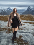 Raccoon Glamour Jacket - Mountain Mirage S/M styled in snowy wilderness, emphasizing thick fur and luxury winter outerwear.