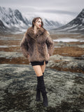 Raccoon Glamour Jacket - Mountain Mirage S/M paired with black mini dress and boots, set against dramatic alpine backdrop for luxury outerwear appeal.