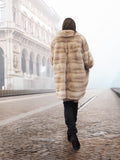 Walking away in blond pastel mink fur coat stroller jacket, highlighting its full coverage and premium fur craftsmanship.