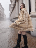 Model turning in blond pastel mink fur coat stroller jacket, perfect for showcasing movement and premium fur texture.