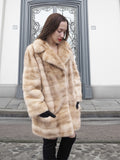 Front view of blond pastel mink fur coat stroller jacket, showcasing its soft texture and modern cut for winter elegance.
