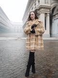Blond pastel mink fur coat stroller jacket styled for city wear, offering timeless warmth and sophistication in winter fashion.
