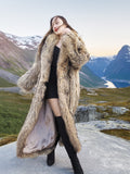 Model posing in Finnish Raccoon Fur Coat with large shawl collar, styled in mountainous terrain for sustainable winter outerwear.