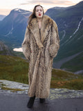 Finnish Raccoon Fur Coat with large shawl collar in natural brown tones, full-length 50" design, modeled in a scenic mountain setting.