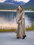 Warm Finnish Raccoon Fur Coat 50" long with voluminous shawl collar, worn outdoors near a lake with mountain backdrop.