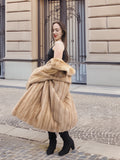 Golden Reverie M - Rear view of vintage mink coat in motion, styled with black boots for a modern twist on classic fur fashion.