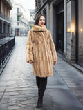 Golden Reverie M - Genuine Blond Mink Coat with double-breasted closure, worn on a cobblestone street for a timeless luxury look.