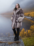 Luxury blue fox fur coat with natural silver tones, modeled in an autumn mountain landscape. Premium fur outerwear for stylish cold-weather wear.