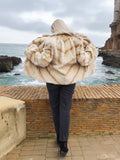 Back view of Reversible Versatile Sheared Mink Fur Jacket Coat S showing wide fur pattern, styled near rocky coastline.
