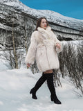 Model walking in snow wearing Soft Plush Blush Fox Jacket S/M, showcasing its full silhouette and premium fox fur design.