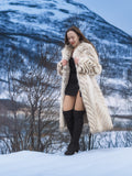 Model in Two Tone Fox Coat Size XS/S walking on snow, highlighting the coat’s chevron fur and elegant full-length silhouette.