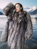 Woman wearing a fur coat with a mountainous landscape in the background