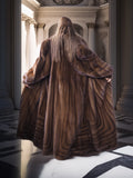 Person wearing a fur coat walking through an elegant interior setting