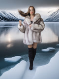 Woman in a fur coat standing on ice with a snowy landscape in the background