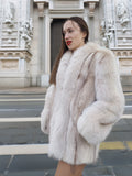 Side view of Brown Cross Mink Fur Coat Jacket S with Blush Fox Trim in front of historic architecture, showcasing timeless elegance and warmth.