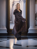 Woman wearing a fur coat in an elegant interior setting