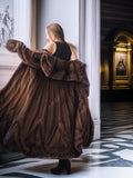 Woman wearing a brown fur coat in an elegant interior setting