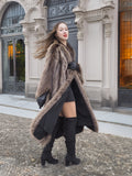 Twirl motion of Canadian Raccoon Fur Coat in silver tips, paired with black mini dress and boots for luxury winter style.