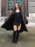 Open view of Canadian Raccoon Fur Coat in silver tips revealing black mini dress, combining luxury fur with modern elegance.