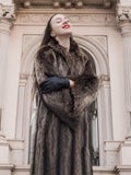 Model wearing Canadian Raccoon Fur Coat in silver tips, showcasing natural fur detail and luxury outerwear appeal in winter setting.
