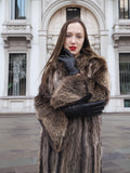 Model in Canadian Raccoon Fur Coat with silver tips, showcasing plush fur sleeves and luxury winter coat design.