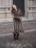 Model in Canadian Raccoon Fur Coat with silver tips, arms crossed for cozy and elegant winter fashion appeal.