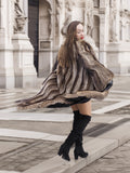 Canadian Raccoon Fur Coat in silver tips twirling motion, showcasing scalloped hem and luxurious fur texture.