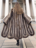 Back view of full-length Canadian Raccoon Fur Coat in silver tips, showcasing scalloped hem and luxurious natural fur texture.