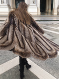 Back twirl of Canadian Raccoon Fur Coat in silver tips, highlighting scalloped hem and full fur movement for luxury fashion.