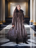 Woman in a fur coat holding a handbag in an elegant interior setting