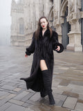 Chic NAFA black mink fur coat styled with knee-high boots, perfect for cold-weather luxury and sophisticated fashion.