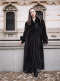 Full-length NAFA black mink fur coat styled with black boots, offering a timeless and luxurious winter fashion look.