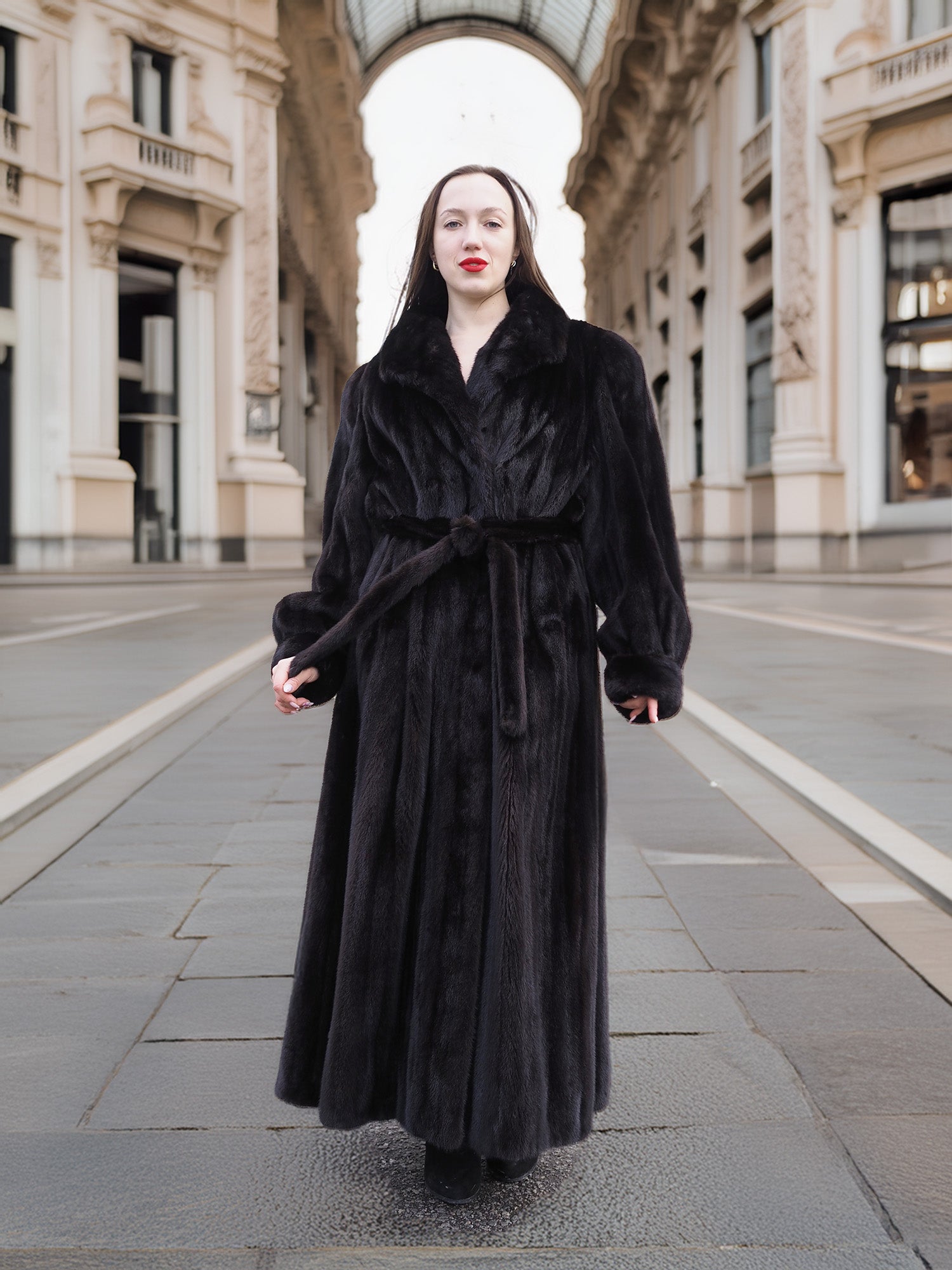Full-length NAFA black mink fur coat with a belted waist, offering a refined and elegant winter outerwear option.