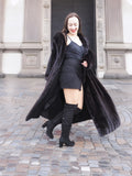 NAFA black mink fur coat worn open over a chic black dress, creating a bold and stylish winter fashion look.