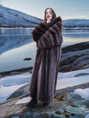 Canadian Raccoon Fur Coat - Silver Tips M styled on snowy rocks. Elegant full-length fur coat for cold weather fashion.
