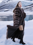 Model walking in snow wearing Canadian Raccoon Fur Coat - Silver Tips M. Elegant and warm fur outerwear for winter.