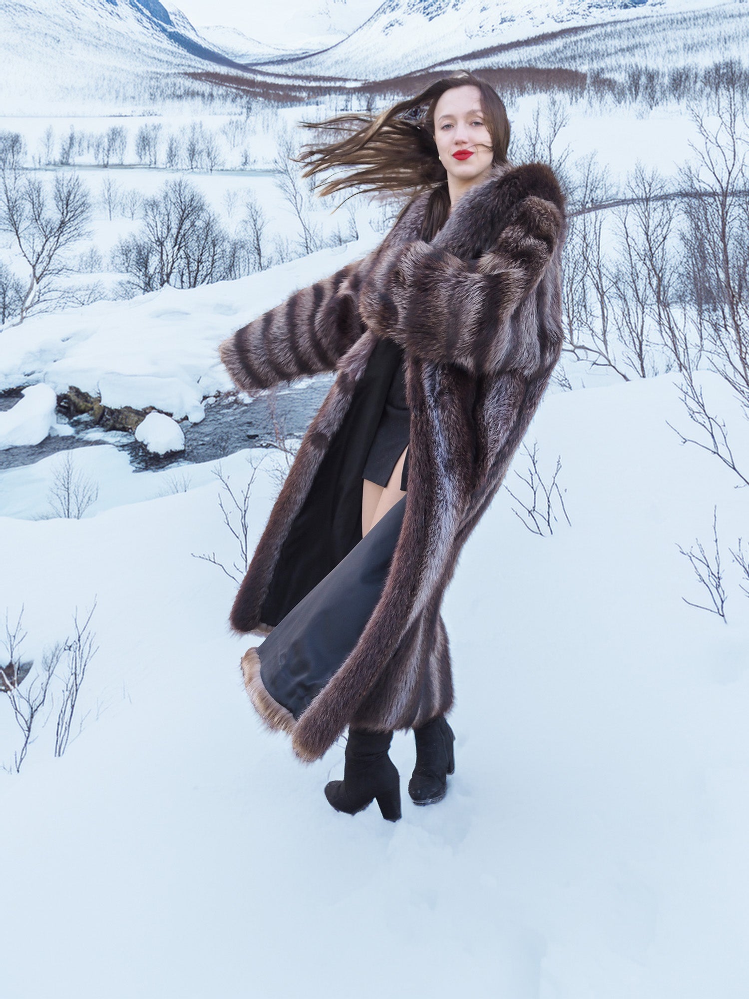 Model twirling in Silver Tip Canadian Raccoon Fur Coat over black outfit. Stylish and cozy winter fur fashion.