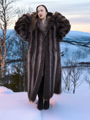 Silver Tip Canadian Raccoon Fur Coat in size M worn in snowy forest. Luxurious full-length fur coat for cold weather.