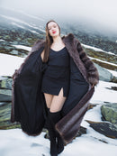 Model showcasing Silver Tip Canadian Raccoon Fur Coat open over black dress. Stylish fur outerwear for winter elegance.