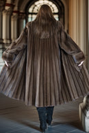 Back view of fine mink coat with hood, flared swing silhouette and ribbed texture