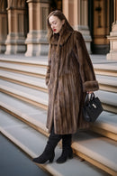 Fine mink coat in demi-buff with hood, buttonless front and rounded fur cuffs
