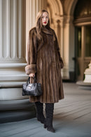 Fine mink coat with hood, vertical fur paneling, long sleeves and full swing skirt