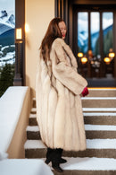Cream fox coat with long sleeves and structured pleated-looking fur panels