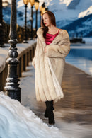 Cream plush fox coat with notch collar, draped front and wide, padded sleeve shape