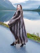 Elegant Canadian Raccoon Fur Coat in silver tips, displayed in motion beside lake, highlighting luxury fur fashion details.
