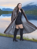 Model walking in open raccoon fur coat revealing satin lining, styled with black mini dress, luxury winter fashion apparel.
