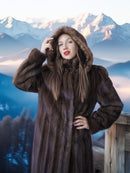 Woman wearing a fur coat with a mountainous background
